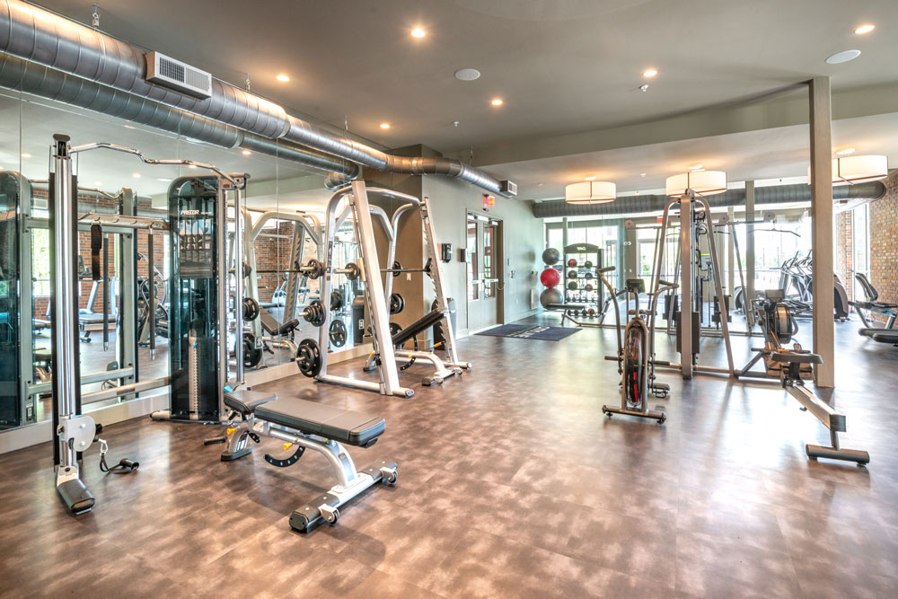 Fitness Center with weight machines, cardio equipment, medicine balls and mirrored walls