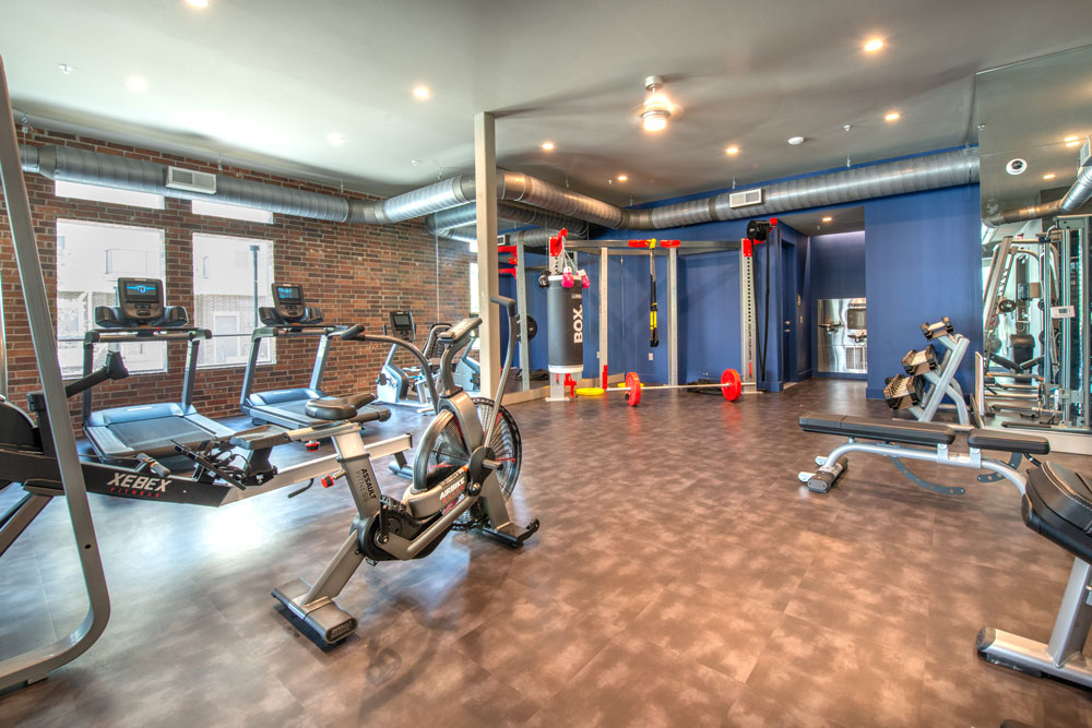 Fitness center with treadmills, spin bikes, ceiling fan and Crossfit station